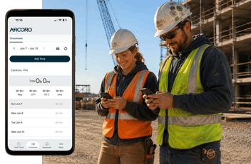 Two construction workers looking at the Arcoro Time mobile app