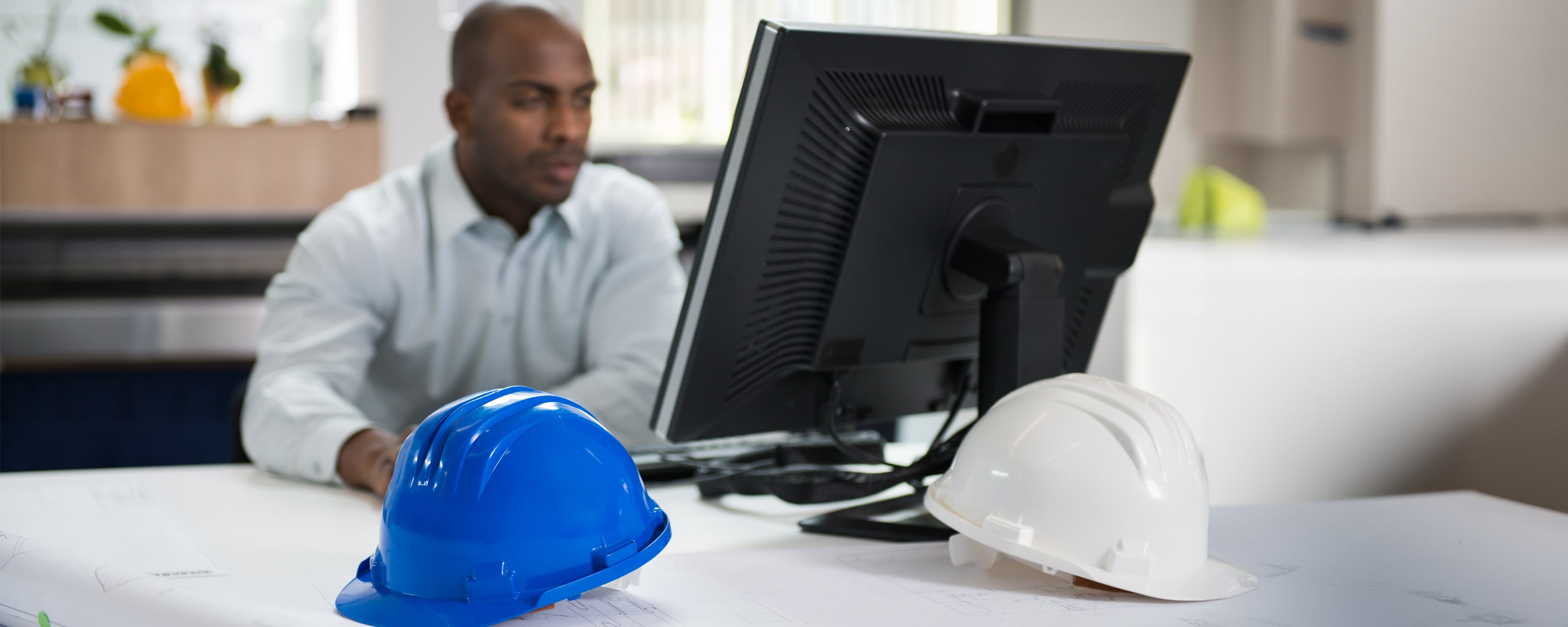 HR construction professional sitting at his desktop