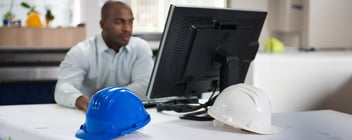 HR construction professional sitting at his desktop