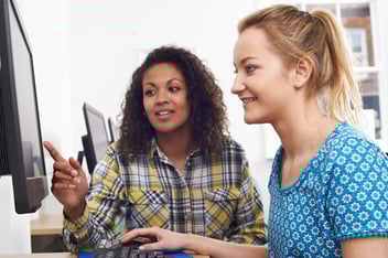 employees-looking-at-computer-collaborating-1
